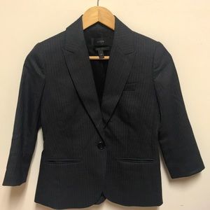 Dark grey pinstriped city fit suit .